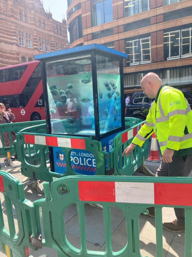 A Banksy artwork depicting piranhas on a police sentry box 