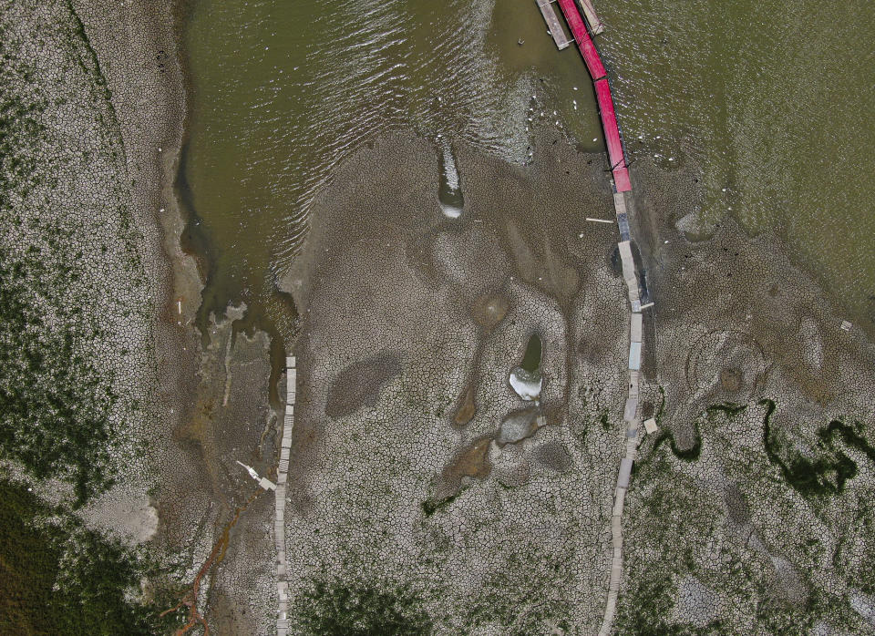 A view of The Boca reservoir that supplies water to the northern city of Monterrey is almost dry as the northern part of Mexico is affected by an intense drought, in Santiago, Mexico, Saturday, July 9, 2022. Local authorities began restricting water supplies in March, as a combination of an intense drought, poor planning and high use has left the three dams that help supply the city dried up, with thousands of homes not receiving any water for weeks. (AP Photo/Fernando Llano)