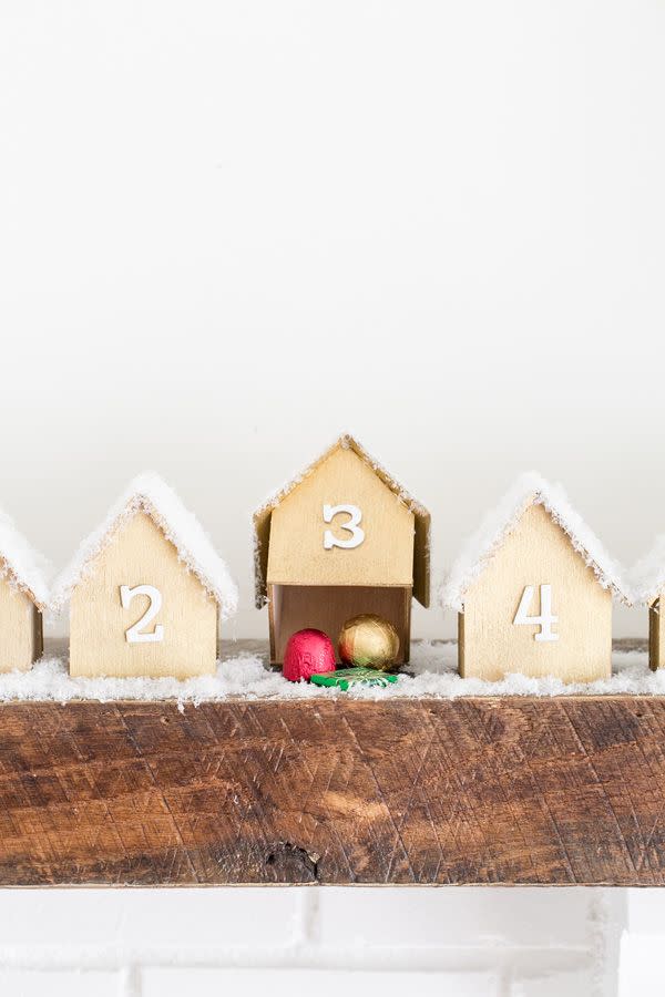 <p>Upgrade your advent calendar tradition with this DIY version from<a href="https://sugarandcharm.com/diy-wooden-houses-advent-calendar" rel="nofollow noopener" target="_blank" data-ylk="slk:Sugar and Charm;elm:context_link;itc:0;sec:content-canvas" class="link "> Sugar and Charm</a>. The little wooden houses are surprisingly easy to make and they're the perfect thing to line the mantle. </p>