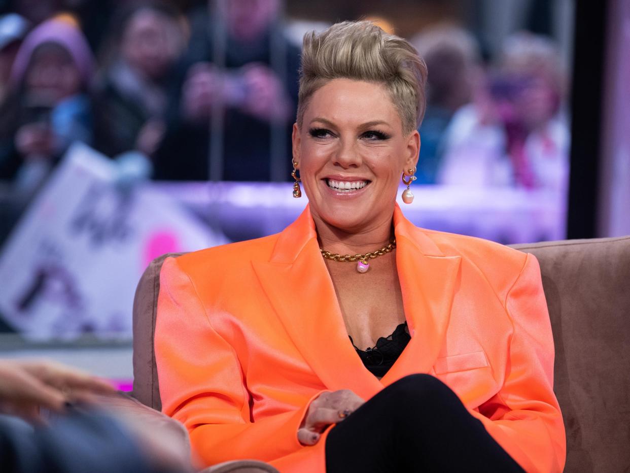 Pink smiling on the Today show in an orange blazer.