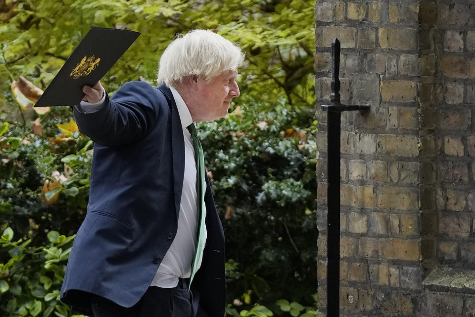 Britain's Prime Minister Boris Johnson waves to reporters on his way to a virtual conference organised by the government of Ukraine and hosted by president Volodymyr Zelensky, in London, Tuesday, Aug. 23, 2022. The Prime Minister will remotely address the international Crimea Platform, a virtual conference.(AP Photo/Frank Augstein)