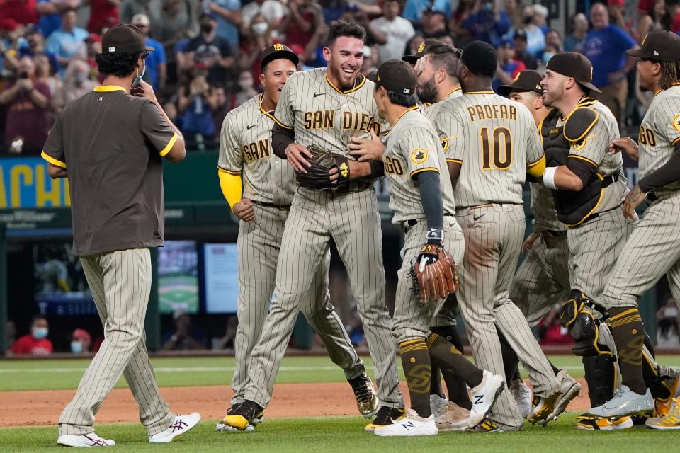 Padres starting pitcher Joe Musgrove (middle) celebrates his no-hitter with his teammates.