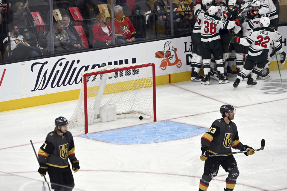 The Minnesota Wild celebrate their overtime victory over the Vegas Golden Knights in Game 1 of a first-round NHL hockey playoff series Sunday, May 16, 2021, in Las Vegas. (AP Photo/David Becker)