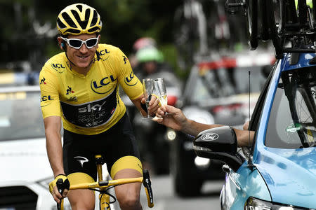 Cycling - Tour de France - The 116-km Stage 21 from Houilles to Paris Champs-Elysees - July 29, 2018 - Great Britain's Geraint Thomas, wearing the overall leader's yellow jersey, and Great Britain Team Sky team principal, Sir Dave Brailsford (R) drink champagne. Marco Bertorello/Pool via REUTERS