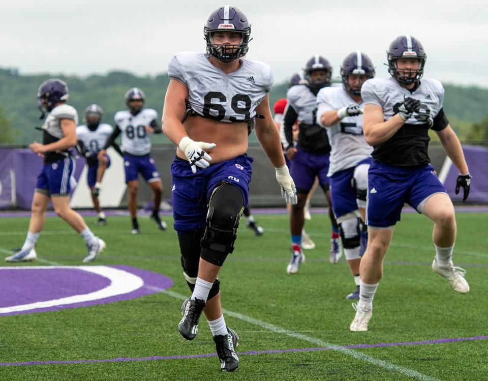 Holy Cross offensive lineman CJ Hanson runs through a drill during practice last week.