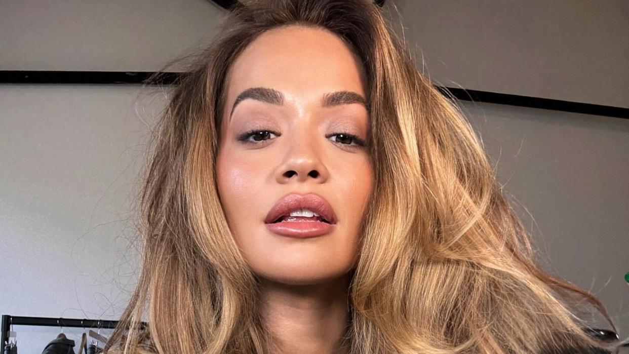 Rita Ora poses on her Instagram in a white tank top