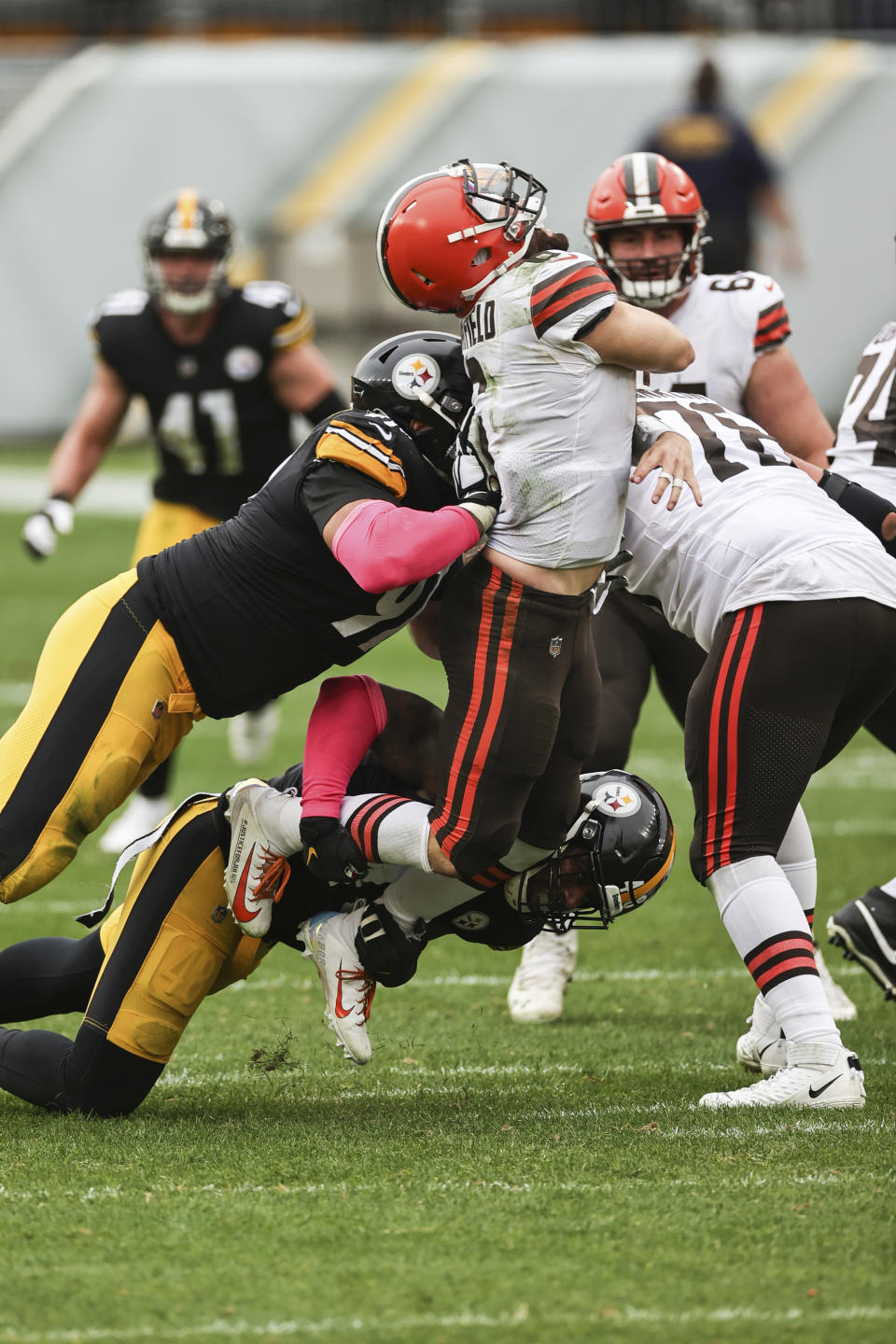 Cleveland Browns quarterback Baker Mayfield (6) is wedged during a sack by Pittsburgh Steelers defensive end Stephon Tuitt (91) in an NFL game, Sunday, Oct. 18, 2020, in Pittsburgh. The Steelers defeated the Browns 38-7. (Margaret Bowles via AP)