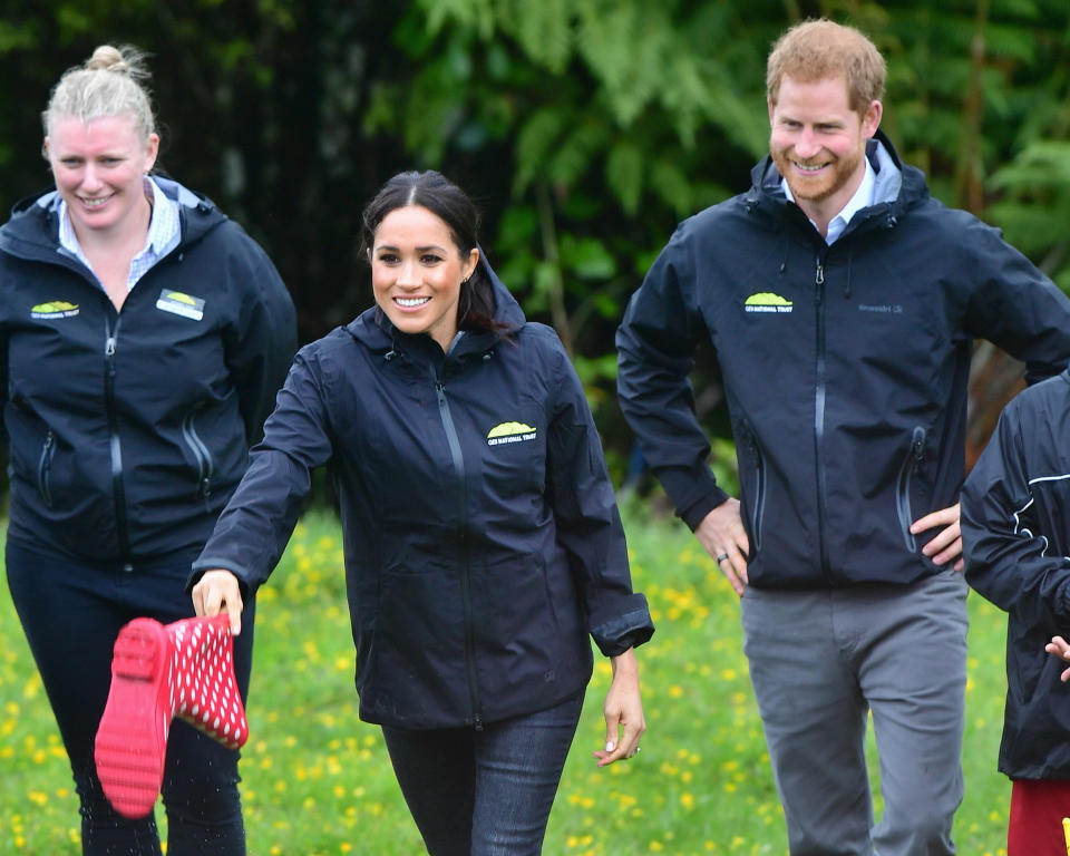 REDVALE, NEW ZEALAND - OCTOBER 30:  Prince Harry, Duke of Sussex and Meghan, Duchess of Sussex participate in a Wellie wanging contest while attending the Unveiling of The Queen's Commonwealth Canopy on October 30, 2018 in Redvale, New Zealand. The Duke and Duchess of Sussex are on their official 16-day Autumn tour visiting cities in Australia, Fiji, Tonga and New Zealand.  (Photo by Samir Hussein/Samir Hussein / WireImage)