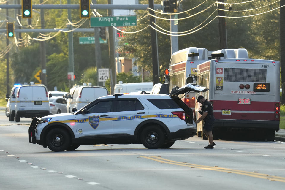 Law enforcement officers investigate the scene of a mass shooting at a Dollar General store Saturday, Aug. 26, 2023, in Jacksonville, Fla. (AP Photo/John Raoux)