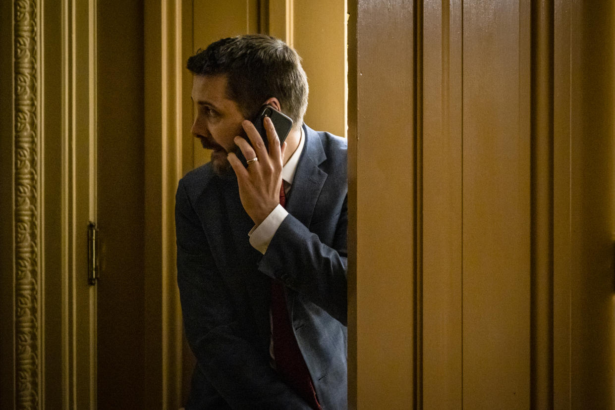 WASHINGTON, DC - JUNE 23: Brian Deese, an economic and political advisor to U.S. President Joe Biden, peeks out of the room where a bipartisan group of Senators and White House officials are holding negotiations over the Biden administrations proposed infrastructure plan at the U.S. Capitol on June 23, 2021 in Washington, DC. After initial negotiations between the White House and Senate Republicans fell through a new bi partisan group of Senators came together with the hopes of reaching a deal for a much need infrastructure spending plan. (Photo by Samuel Corum/Getty Images)