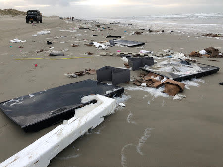 Flat-screen television sets and debris lie washed up on a beach in Terschelling, Netherlands January 2, 2019 in this image obtained from social media. Erik Scheer via REUTERS