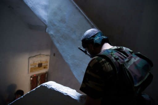 A rebel from the Free Syrian Army (FSA) stands in the stairwell of a building being used as an access route in the Salaheddin district of the northern restive city of Aleppo on August 10. The battle for Syria is raging on the ground but also on social media, where people on both sides of the conflict are hacking, posting and spamming in a frenzied propaganda war