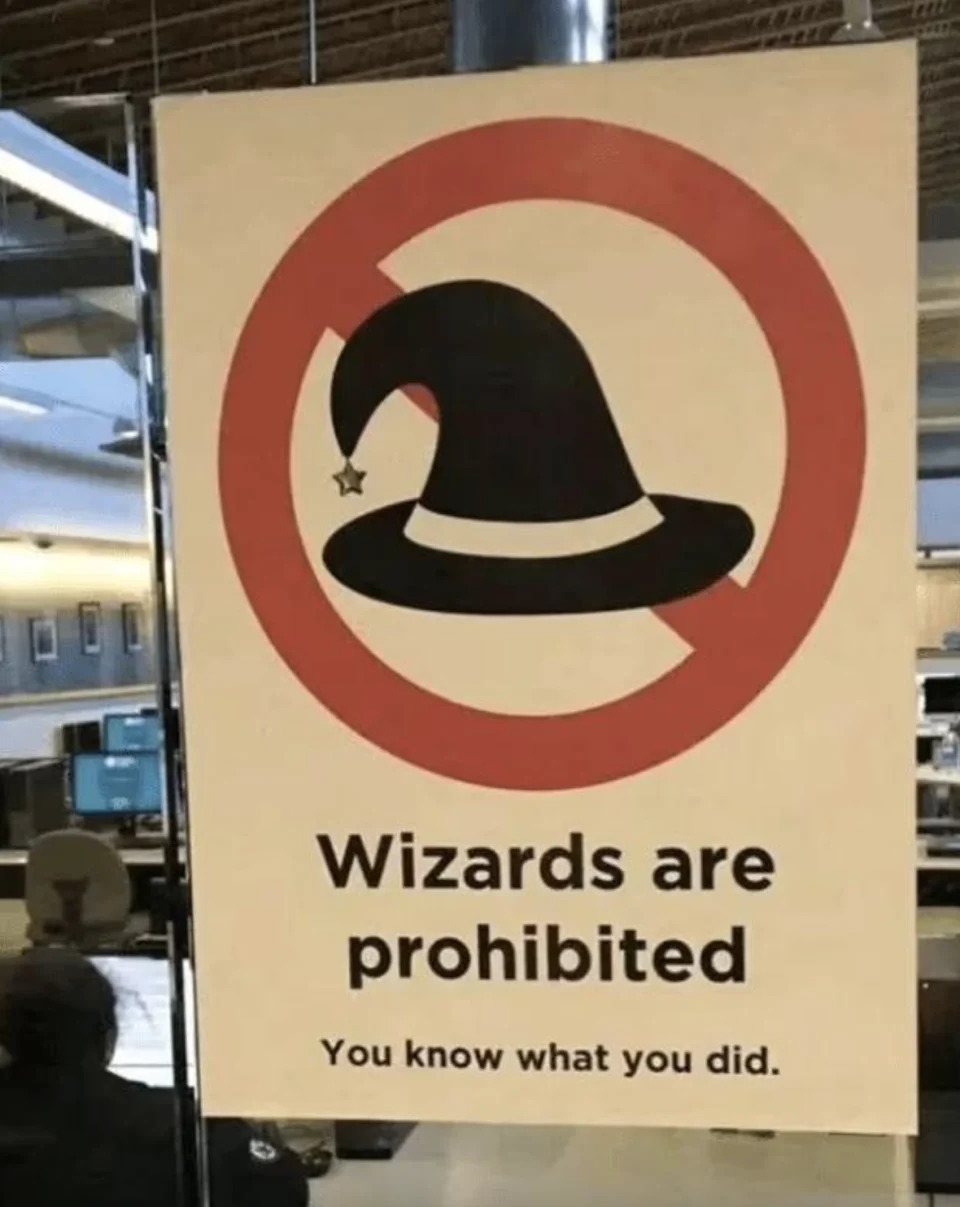 Sign saying "Wizards are prohibited - You know what you did" with a wizard hat in a prohibition circle