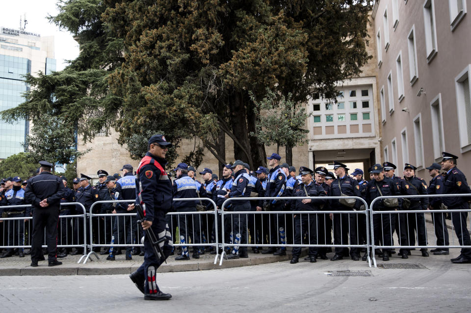 Policemen line up outside the Prime Minister's office ahead of an anti-government rally in Tirana, Albania on Saturday, March 16, 2019. The center-right opposition Democratic party demands the government's resignation, accusing the Cabinet of corruption and opposition lawmakers have relinquished their seats in parliament and they have rejected calls for dialogue from Socialist Prime Minister Edi Rama and from the U.S. and European Union. (AP Photo/Visar Kryeziu)