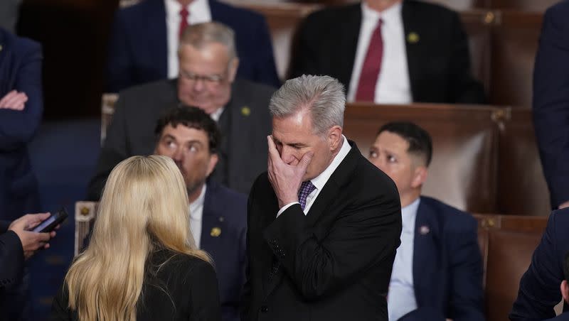 Rep. Kevin McCarthy, R-Calif., talks with Rep. Marjorie Taylor Greene, R-Ga., at the beginning of an evening session after six failed votes to elect a speaker and convene the 118th Congress in Washington on Jan. 4, 2023.