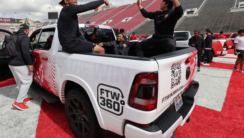 Utah Utes scholarship football players celebrate getting a Dodge truck given to them by the Crimson Collective during an NIL announcement at Rice-Eccles Stadium in Salt Lake City on Oct. 4, 2023. Five Utah universities are challenging a State Records Committee decision that college athletes’ name, image and likeness contracts are public records.