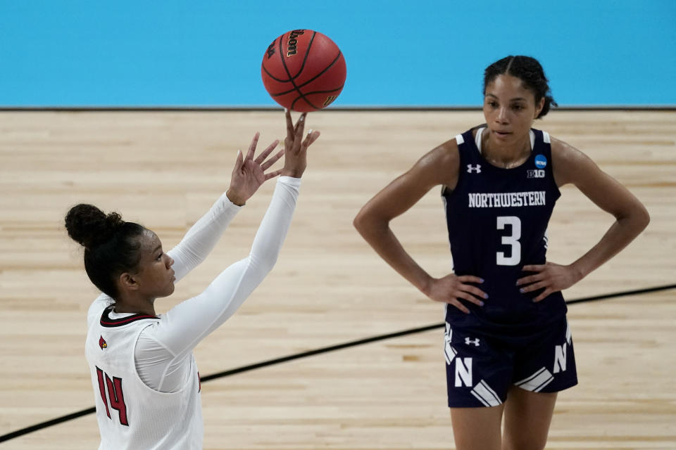 Louisville guard Kianna Smith (14) shoots a free throw while Northwestern guard Sydney Wood (3) watches during the second half of a college basketball game in the second round of the women's NCAA tournament at the Alamodome in San Antonio, Wednesday, March 24, 2021. Louisville won 62-53. (AP Photo/Charlie Riedel)