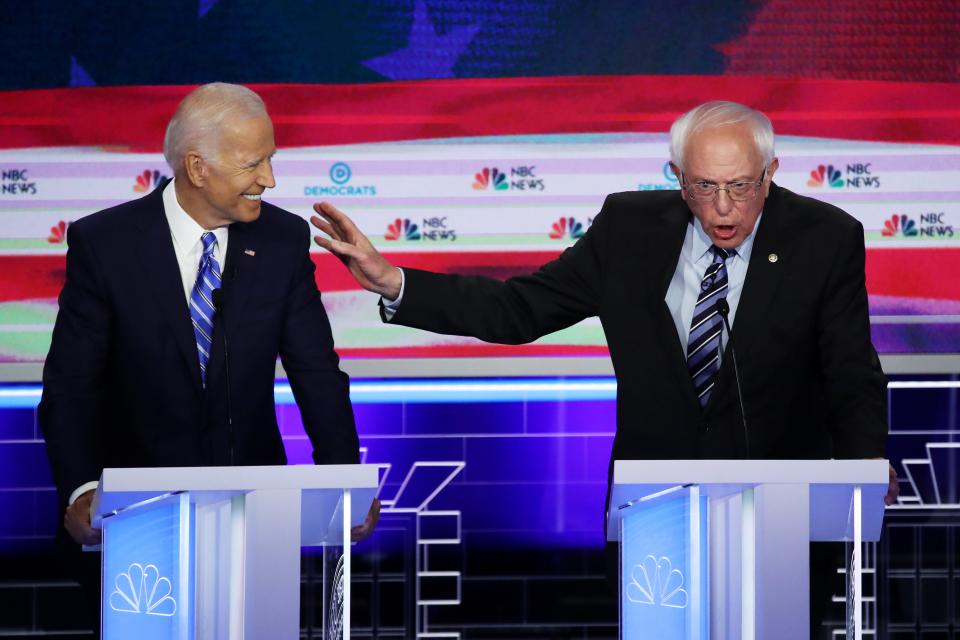 Democratic presidential candidates former Vice President Joe Biden and Sen. Bernie Sanders (I-VT) speak during the second night of the first Democratic presidential debate on June 27, 2019 in Miami, Florida.