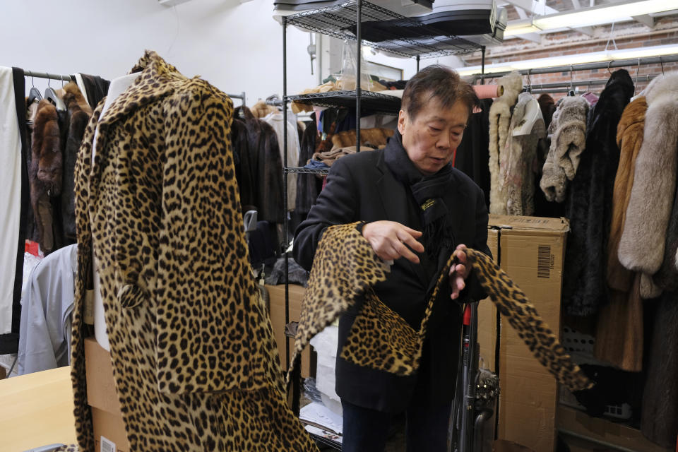 FILE - In this Friday, March 16, 2018, file photo Benjamin Lin looks over a 60-year-old cheetah jacket he is restoring at the B.B. Hawk showroom in San Francisco. California will be the first state to ban the sale and manufacture of new fur products and the third to bar most animals from circus performances under a pair of bills signed Saturday, Oct. 12, 2019 by Gov. Gavin Newsom. (AP Photo/Eric Risberg, File)