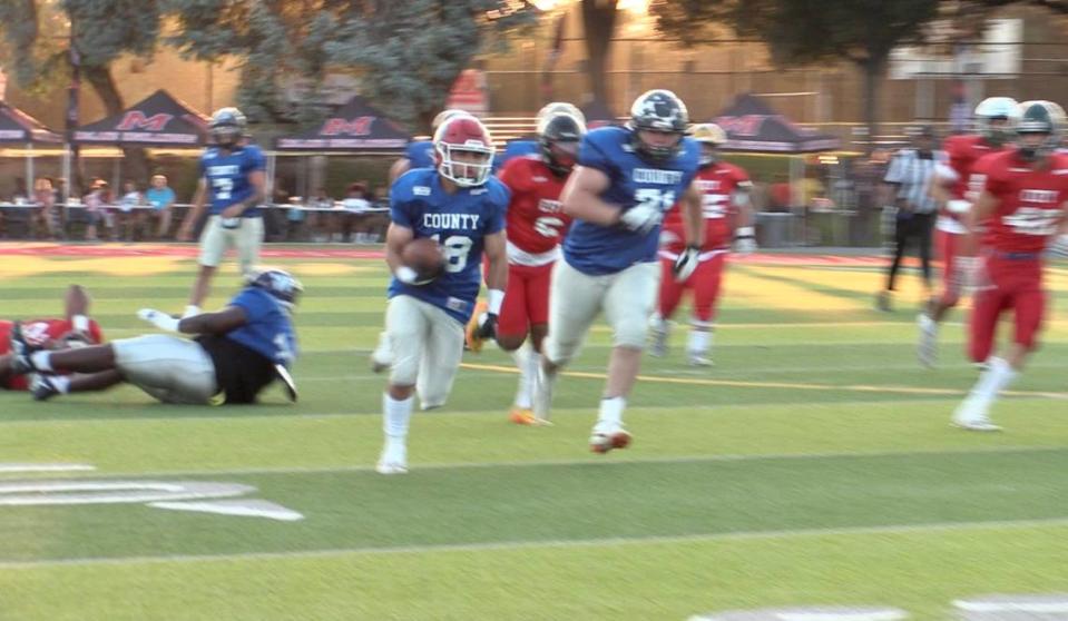 The County’s Ashton Chalabian of Kerman runs for yards during the 69th City/County All-Star football game at McLane Stadium in Fresno, California on Friday, June 17, 2023.