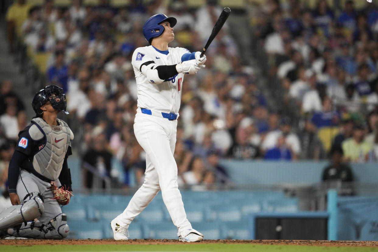 Los Angeles Dodgers designated hitter Shohei Ohtani (17) hits a home run during the sixth inning of a baseball game against the Cleveland Guardians in Los Angeles, Friday, Sept. 6, 2024. (AP Photo/Ashley Landis)