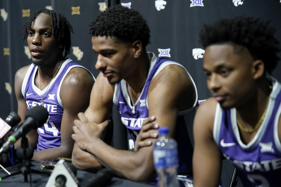 Kansas State's Arthur Kaluma, left, speaks to the media while David N'guessan, center, and Tylor Perry look on during the NCAA college Big 12 men's basketball media day Wednesday, Oct. 18, 2023, in Kansas City, Mo. (AP Photo/Charlie Riedel)