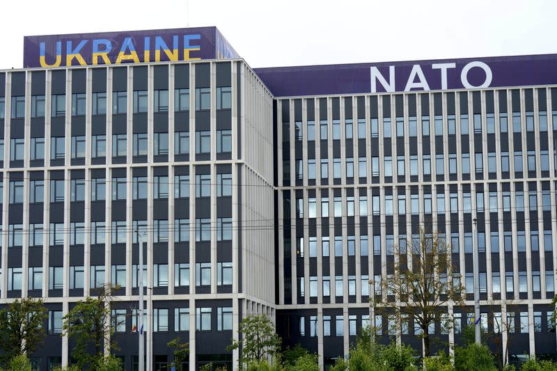 Ukraine and NATO signs are seen on a building in Vilnius