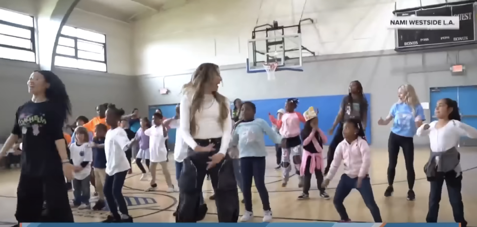 Children and adults dancing in a gym