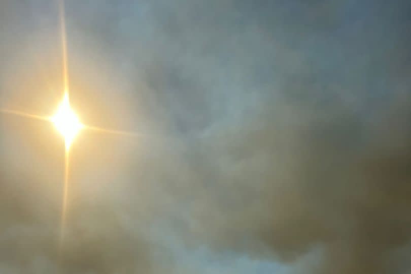 The clouds in the sky caused by smoke from the wildfires