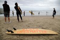 People attend The Black Girls Surf paddle-out in memory of George Floyd, who died in Minneapolis police custody, in Santa Monica