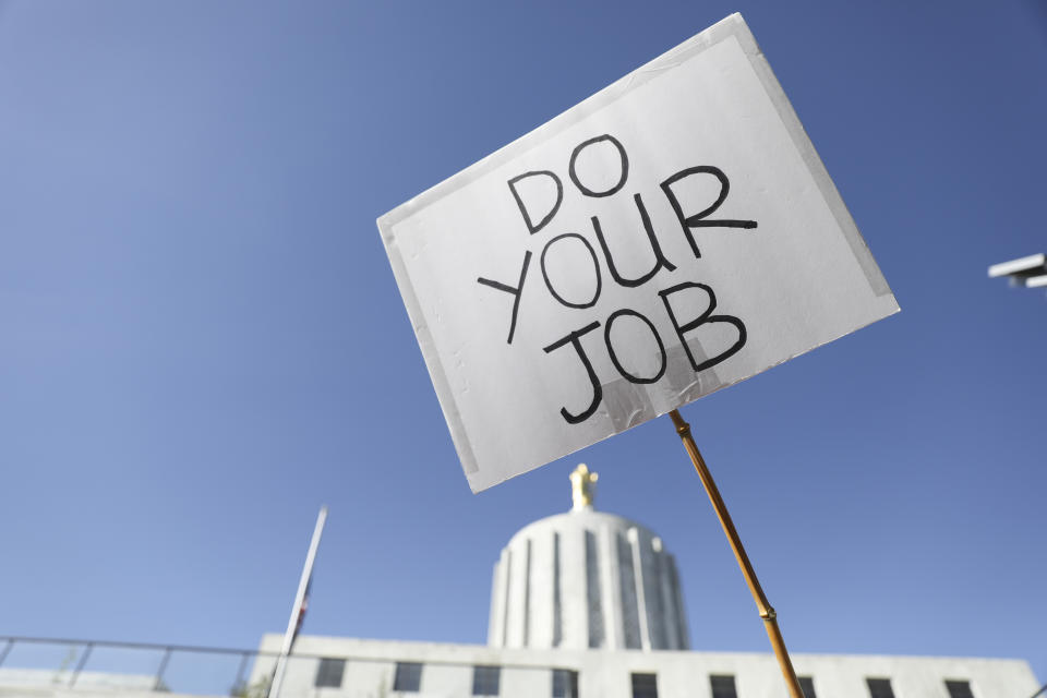 FILE - An attendee holds up a sign during a rally calling for an end to the Senate Republican walkout at the Oregon State Capitol in Salem, Ore., Thursday, May 11, 2023. The longest-ever walkout in the Oregon Legislature reached its fourth week on Wednesday, May, 31, 2023, as the enforceability of a ballot measure that would disqualify the boycotters from reelection in their next term appeared in doubt. (AP Photo/Amanda Loman, File)