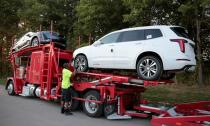 A car hauler delivers two Cadillac XT6 vehicles to La Fontaine Cadillac dealership in Highland, Michigan,