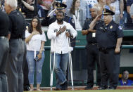 <p>Injured Capitol Hill Police officer David Bailey, center, holds his hand over his heart during the National Anthem with U.S. Capitol Police Chief Matthew Verderosa, far right, before the Congressional baseball game, Thursday, June 15, 2017, in Washington. The annual GOP-Democrats baseball game raises money for charity. (Photo: Alex Brandon/AP) </p>