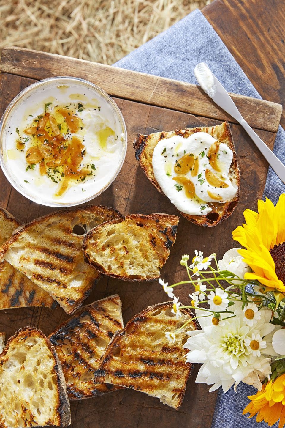 whipped ricotta and grilled bread on a wooden serving board