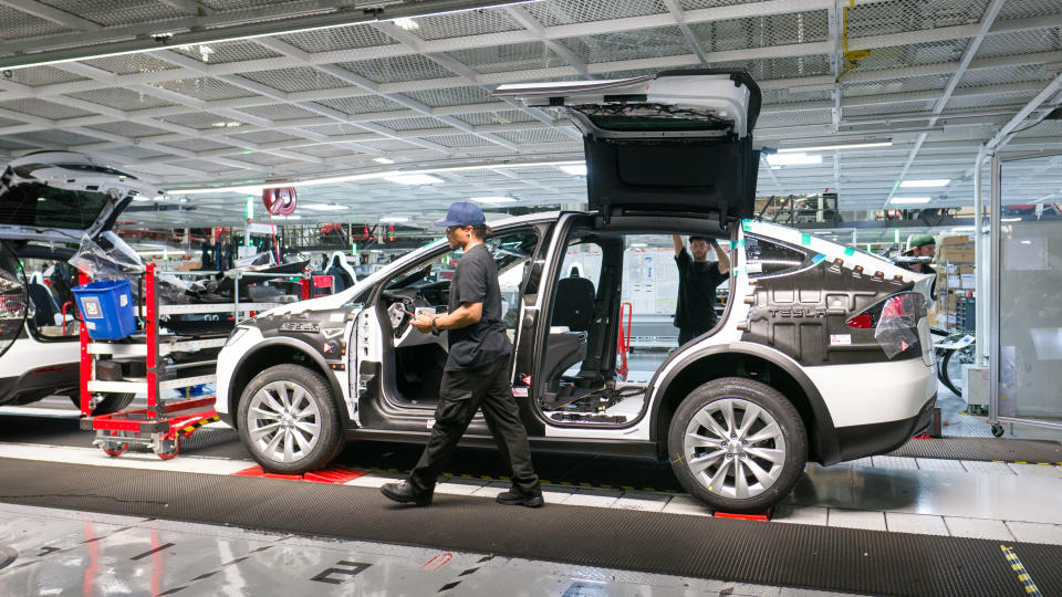 An employee working on a Model X at Tesla's factory in Fremont, California.