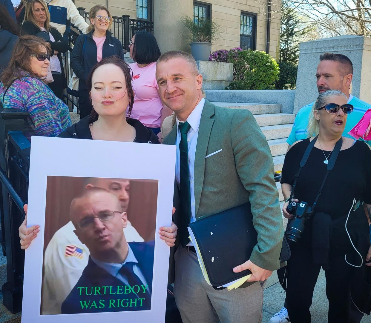 Aidan Kearney, the Holden blogger known as Turtleboy, poses for a photo with a supporter Tuesday prior to a hearing in his criminal cases in Norfolk Superior Court.