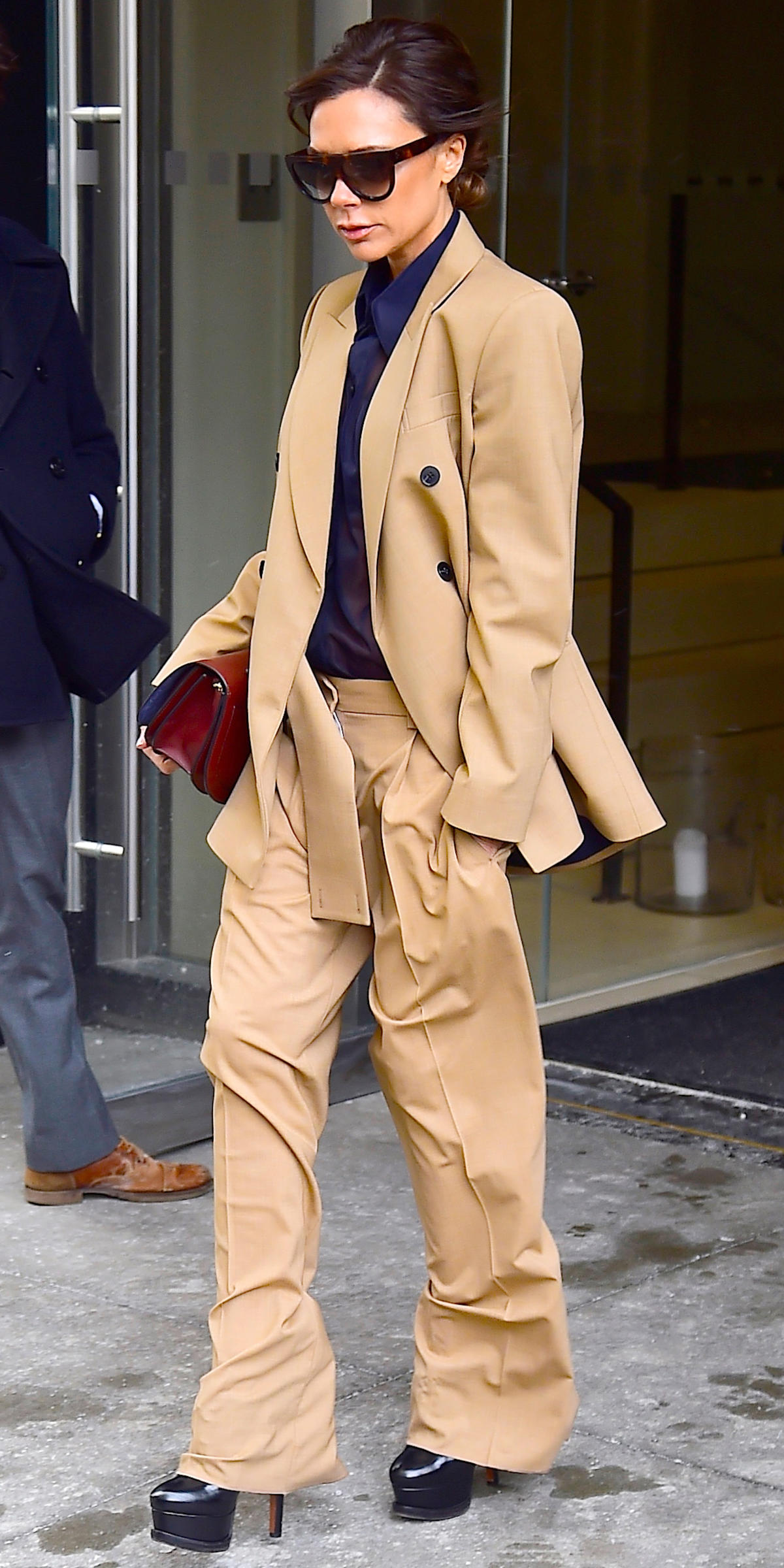 Victoria Beckham Wearing Silk Pants at the Airport