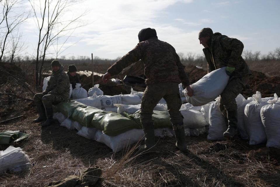 Ukrainian servicemen pile up earthbags to build a fortification not far from the town of Avdiivka in Donetsk Oblast, amid the Russian invasion of Ukraine, on Feb. 17, 2024. (Photo by Anatolii Stepanov /AFP via Getty Images)