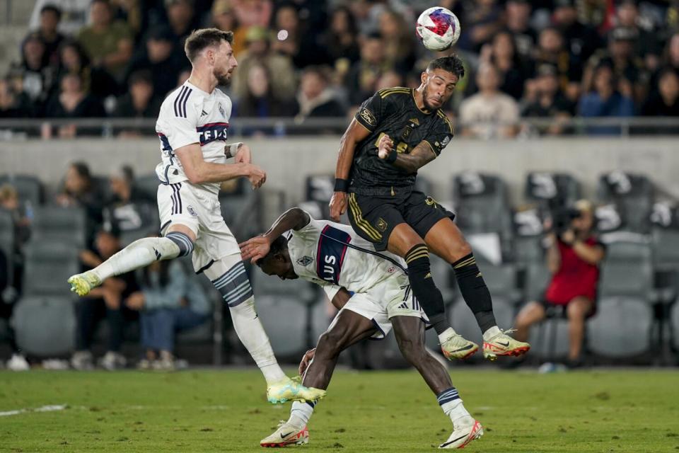 LAFC forward Denis Bouanga and Vancouver Whitecaps midfielder Richie Laryea and defender Tristan Blackmon vie for the ball.