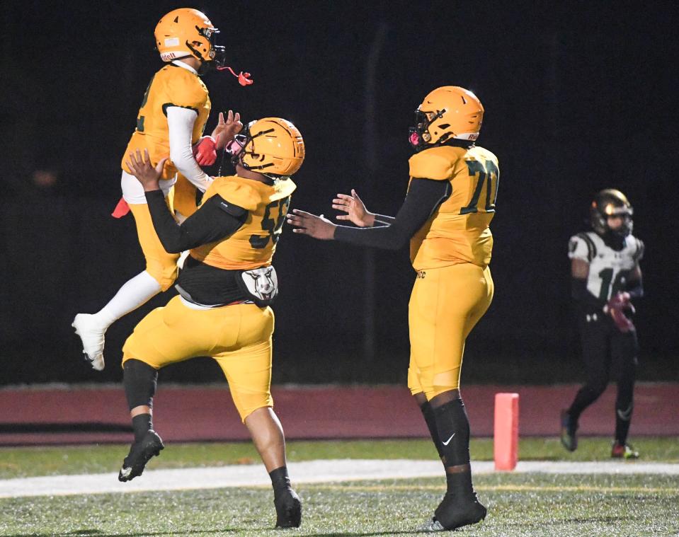 Ramel Hernandez of Melbourne Central Catholic celebrates his touchdown against Trinity Catholic with teammates Jayden Jordan and Javeion Cooper in the FHSAA Region 2-1S football finals November 24, 2023. Craig Bailey/FLORIDA TODAY via USA TODAY NETWORK