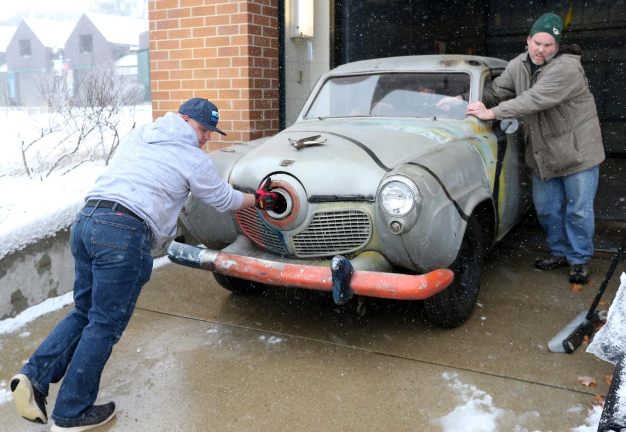 Razorfly Studios owner Mark Zoran, left, and Studebaker National Museum archivist Andrew Beckman push the 1951 Studebaker Commander that was in the 1979 film "The Muppet Movie" as it's loaded from the museum onto a trailer Friday, Jan. 12, 2024, in South Bend.