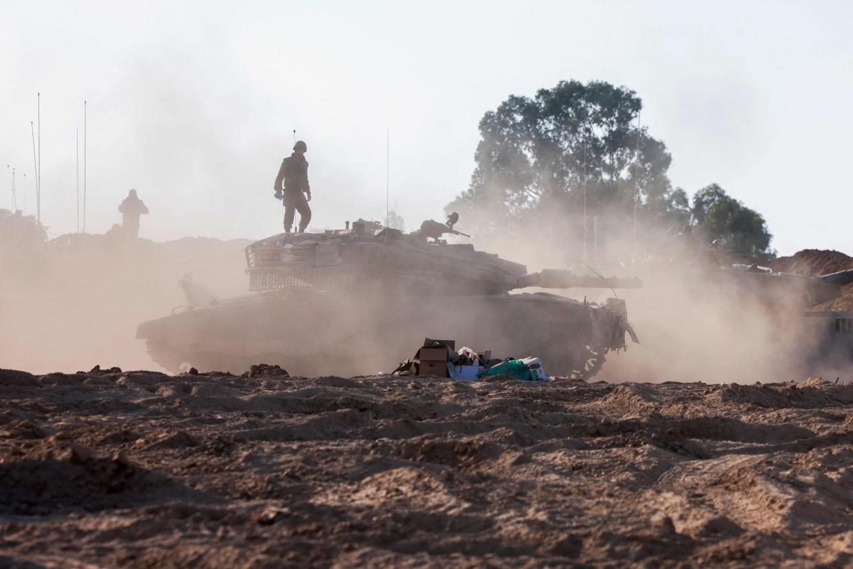 Soldiers of the Israeli tanks unit stand atop their armoured vehicles Thursday positioned along the border with Gaza. Thousands of people, both Israeli and Palestinian, have died since October 7, after Palestinian Hamas militants entered Israel in a surprise attack.