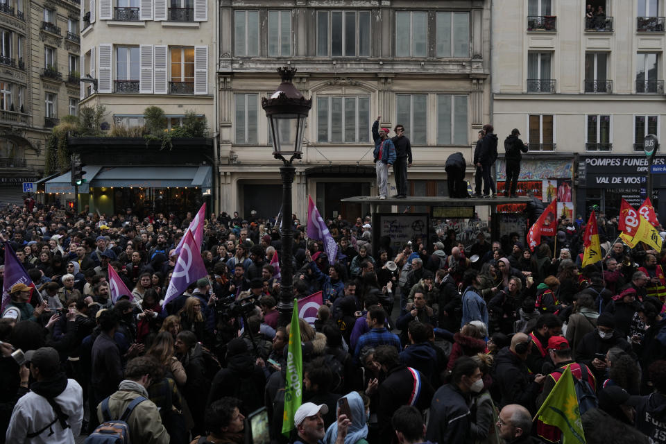 People demonstrate after French President Emmanuel Macron seeked to diffuse tensions in a televised address to the nation, Monday, April 17, 2023 in Paris. Emmanuel Macron said Monday that he heard people's anger over raising the retirement age from 62 to 64, but insisted that it was needed. In an televised address to the nation, Macron said "this changes were needed to guarantee everyone's pension," after he enacted the pension law on Saturday. (AP Photo/Thibault Camus)