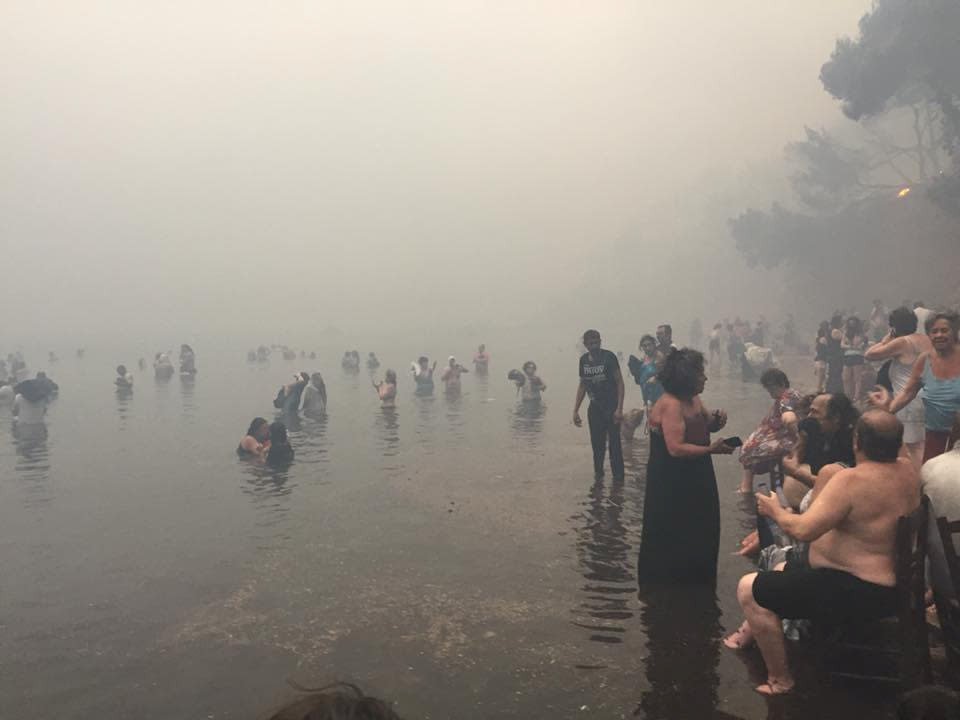 <p>People are seen as a wildfire burns in Mati, Greece July 23, 2018 in this picture obtained from social media on July 24, 2018. (Photo: Kalogerikos Nikos via Reuters) </p>