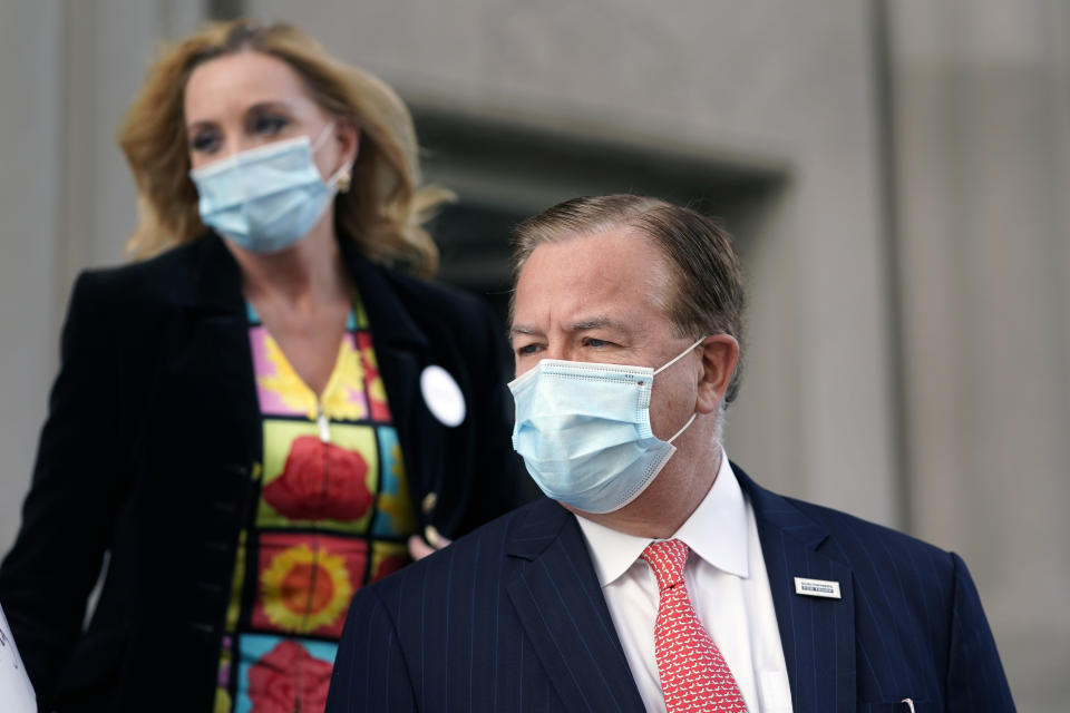 Mark and Patricia McCloskey leave following a court hearing Wednesday, Oct. 14, 2020, in St. Louis. The McCloskeys have pleaded not guilty to two felony charges, unlawful use of a weapon and tampering with evidence, after been seen waving guns at protesters marching on their private street this past summer. (AP Photo/Jeff Roberson)