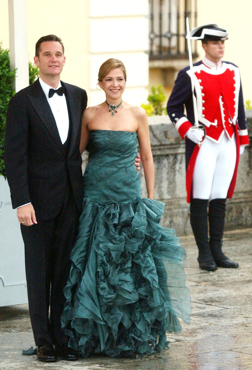 In this May 21, 2004 file photo, Spain's Princess Cristina, centre and her husband Inaki Urdangarin arrive at The Pardo Palace on the outskirts of Madrid for a dinner for guests attending the wedding of Crown Prince Felipe and Letizia Ortiz. In an unprecedented court appearance on Saturday Feb. 8, 2014 for a direct descendent of a Spanish king, Princess Cristina will answer questions from a judge who has formally named her as a fraud and money laundering suspect. The case is a direct offshoot of one led by the same judge in an investigation of her husband Inaki Urdangarin for allegedly using his position as the Duke of Palma to embezzle public contracts via the Noos Institute, a supposedly nonprofit foundation he set up that channeled money to other businesses. Spain’s royal family just wants the case that has now dragged on for years to end rapidly so the monarchy can try to rebuild the trust it once had. (AP Photo/Paul White File)