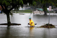 <p>A woman pushes her bicycle through flooding caused by Hurricane Lane in Hilo, Hawaii, Aug. 25, 2018. (Photo: Terray Sylvester/Reuters) </p>