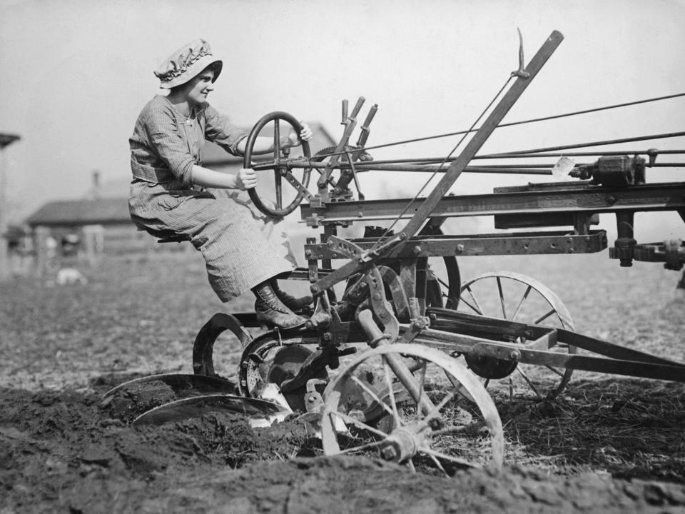 A woman operates a plough in 1925.