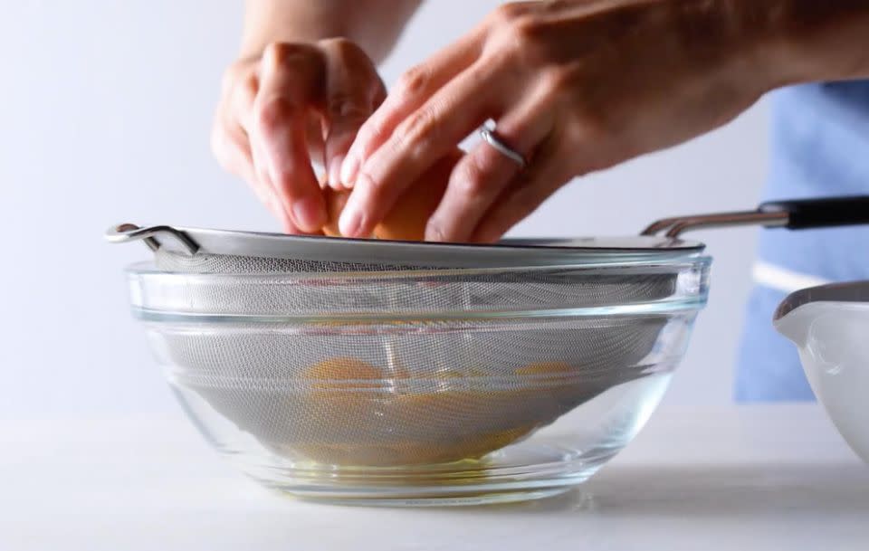 First you should strain your eggs in a sieve. Source: Food52 / Vimeo