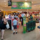 Police officers distribute toilet papers and paper towels to the customers at Woolworths supermarket, in Prospect